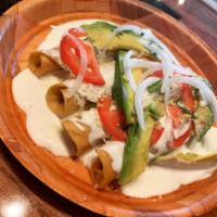 Potatoes Flautas · Fried until golden and crispy rolled tacos, filled with mashed potatoes and garnished with M...