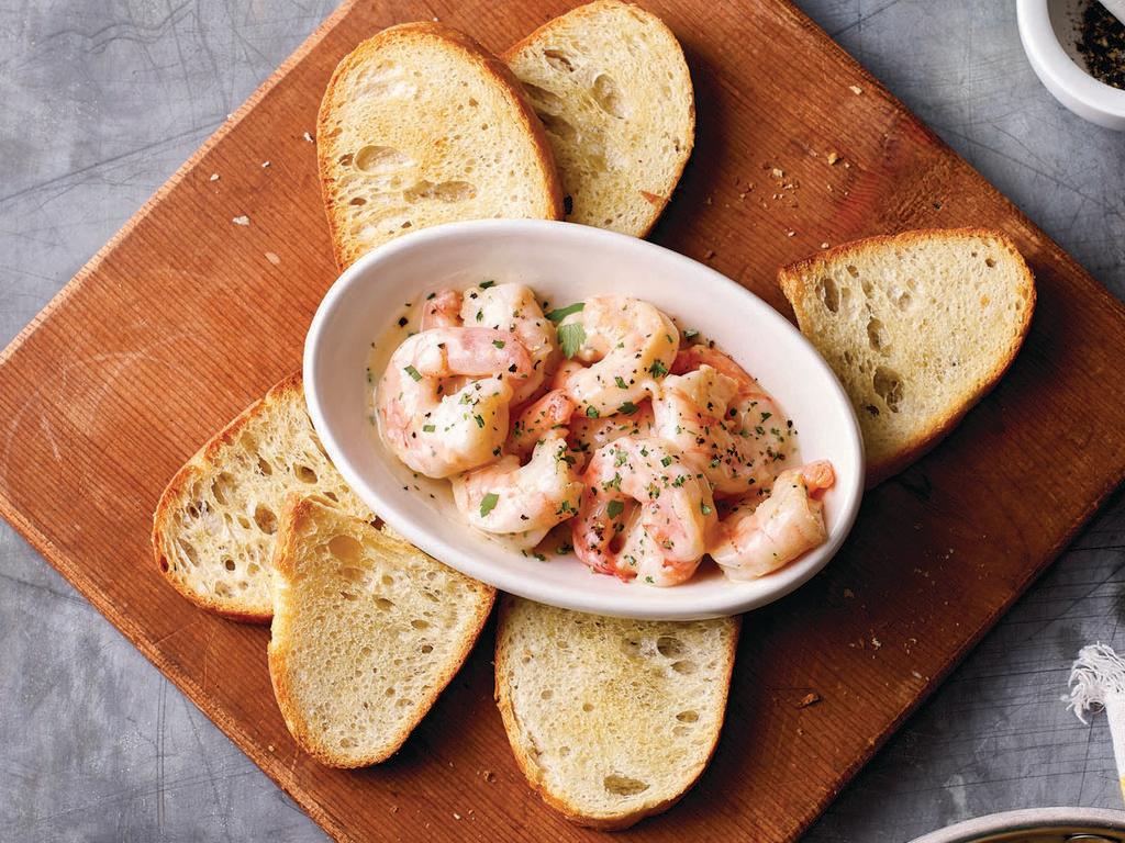 Shrimp Scampi · Garlic, white wine, and our lemon butter sauce served with baked bread.