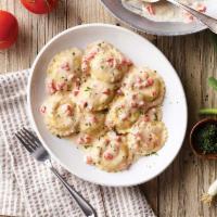 Lobster Ravioli · Ravioli stuffed with lobster and Romano in our white wine cream sauce topped with diced toma...
