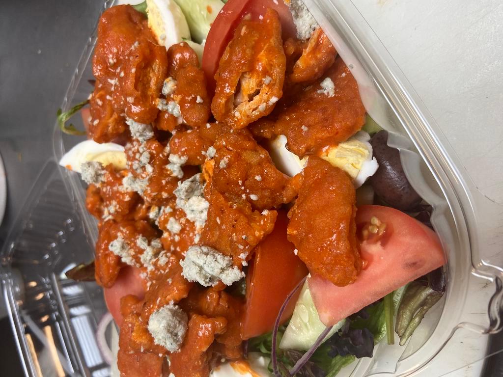 Buffalo Chicken Salad · Our house salad with spicy crispy or grilled chicken with bleu cheese crumble. Served with garlic bread.