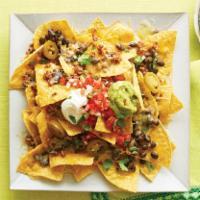 Loaded Nachos · Tortilla chips, your choice of protein, beans, cheese, pico de gallo, sour cream, and guacam...