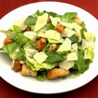 Side Caesar Salad · Crisp romaine lettuce, Parmesan and croutons served with creamy Caesar dressing.
