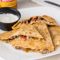 Phillydilla Sandwich · 6 oz of Thin sliced rib eye, American cheese and peppers stuffed in between to large tortilla.