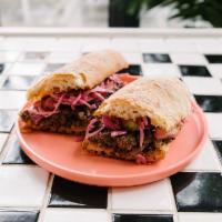 Brisket Sandwich · slow-cooked brisket, coconut curry slaw, toasted stirato 