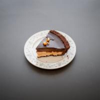 Slice of Chocolate Peanut Butter Pie · Chocolate Cookie crust with a layer of Peanut Butter Mousse and Chocolate Mousse, topped wit...