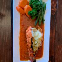 Grilled Lobster Tail/Cola de Langosta a la Parrilla  · Delicious Grilled lobster tail served in marinara or seafood sauce. Accompanied with side of...
