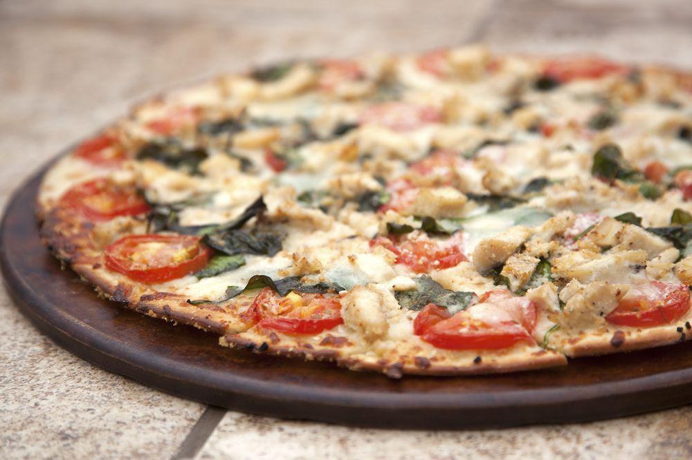 Chicken Spinach Mozzarella Pizza · Sliced chicken breast, fresh baby spinach, fresh mozzarella, freshly cut Roma tomatoes, roasted garlic, Romano, olive oil (instead of red sauce).