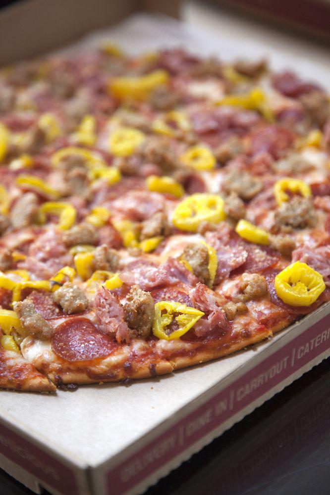 Founder's Favorite Pizza · Heritage pepperoni, family recipe sausage, shaved ham, banana peppers, smoked provolone, Romano.