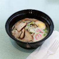 Tonkotsu Ramen · A rich, pork-based broth topped with chashu (pork belly) slices.