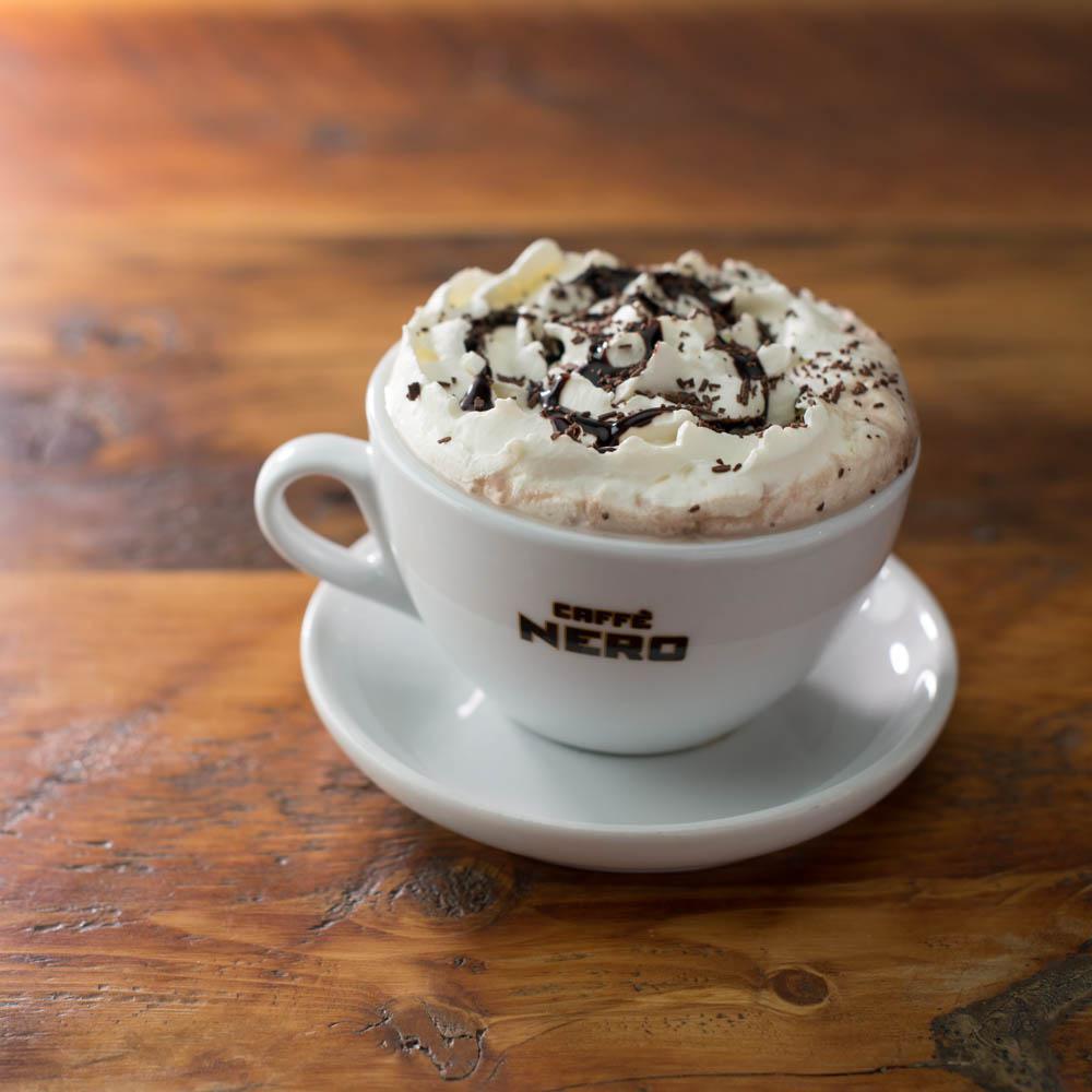 Hot Chocolate · Comforting, sweet and milky chocolate drink topped with whipped cream and Belgian chocolate sprinkles.
