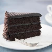 Mile High Chocolate Cake · A decadent chocolate sponge cake layered with a smooth fudge cream and generously covered wi...