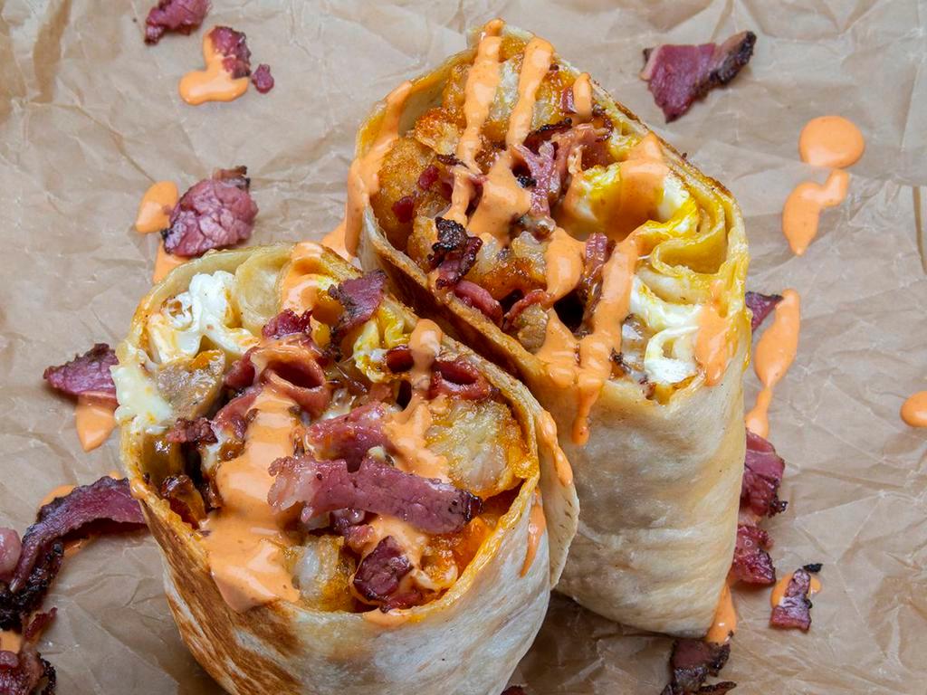 Chachi Burrito · 3 eggs, Italian sausage, pastrami, white American cheese, mozzarella cheese, crispy tater tots, spicy mayo; sides of spicy mayo & hot sauce.