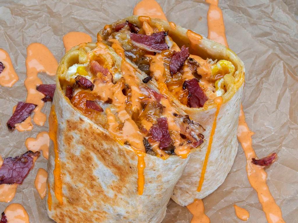 Pastrami Burrito · 3 eggs, pastrami, white American cheese, crispy tater tots, spicy mayo; sides of spicy mayo & hot sauce.