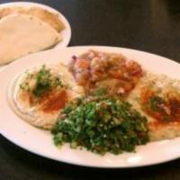 Salad Combo · Hummus, tabbouleh, baba ghanoush, eggplant salad, and two pitas.