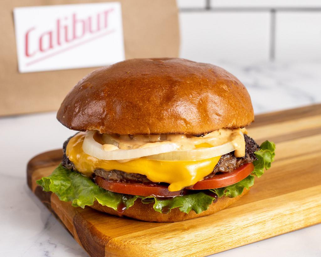 Single Cheeseburger by Calibur Express · By Calibur Express. 1/4 lb fresh, organic, grass fed California beef with American cheese. Served with lettuce, tomato, yellow onion, and Calibur sauce on the side. Contains gluten, dairy, soy, nightshades, and eggs. We cannot make substitutions.
