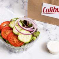 Side Salad · Fresh, organic spring mix. Topped with red onion, tomato, and cucumbers. Served with ranch o...