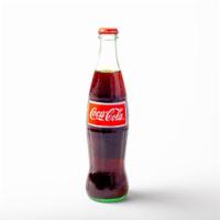 Mexican Coke · 12 oz glass bottle of Coke, sweetened with real cane sugar.