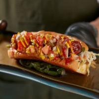 The MVP Sonora Dog · Applewood bacon wrapped hot dog on griddled bun with griddled onions, peppers, pickled cabba...