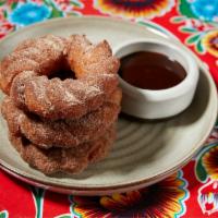 Churro Donuts · 3 Warm Donuts tossed with Cinnamon & Sugar served with Ghirardelli chocolate sauce.