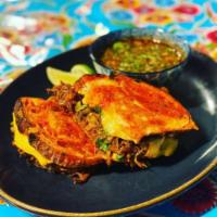 Birria Grilled Cheese  · Artisan Achiote Garlic Sourdough with prime beef birria, American & jack cheese. Served with...