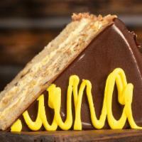 BANANA LAYER CAKE · Moist banana cake, rich banana cream, chocolate chips, walnuts and milk chocolate icing. 