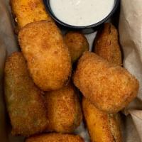 Jalapeno Poppers · Breaded jalapeno peppers stuffed with cheddar cheese served with ranch.