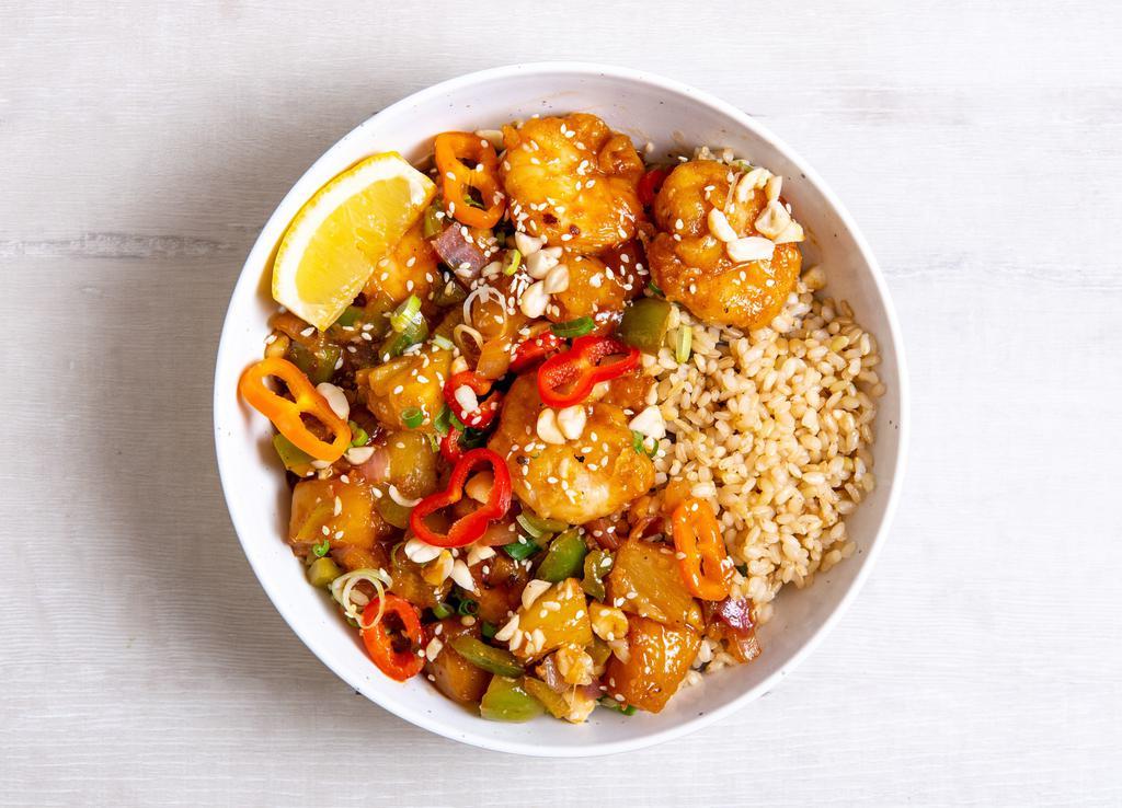 Gluten-Free Sweet & Sour Tofu · Sesame tofu with roasted pineapple, charred peppers, sauteed onions, roasted salt-free peanuts, green onions, sesame seeds, and our house-made sweet and sour sauce.  Served with a lemon wedge, and a base of your choice. Gluten-free.
