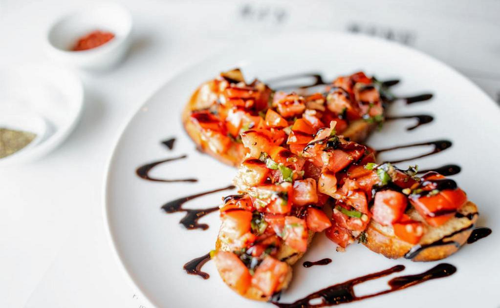 Bruschetta · Toasted bread, tomatoes, garlic, basil, olive oil and balsamic reduction.