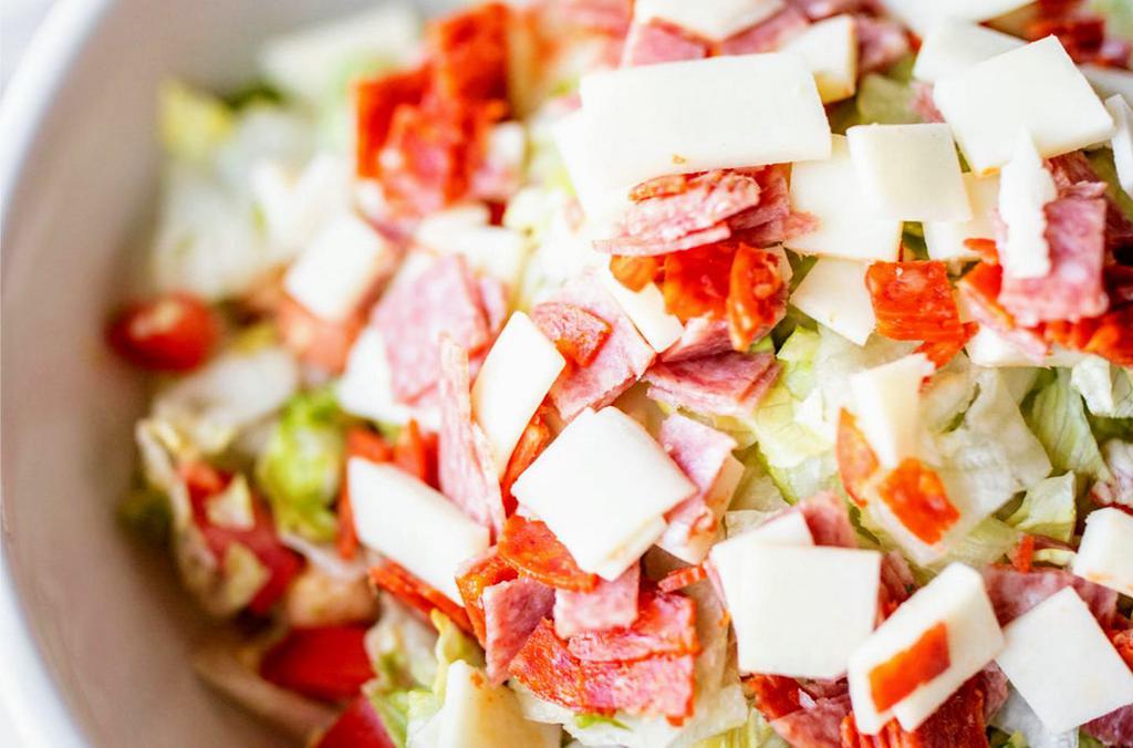 Chopped Salad · Chopped iceberg lettuce, tomatoes, pepperoncini, garbanzo beans, salami, pepperoni, provolone cheese, tossed in red wine vinaigrette.
