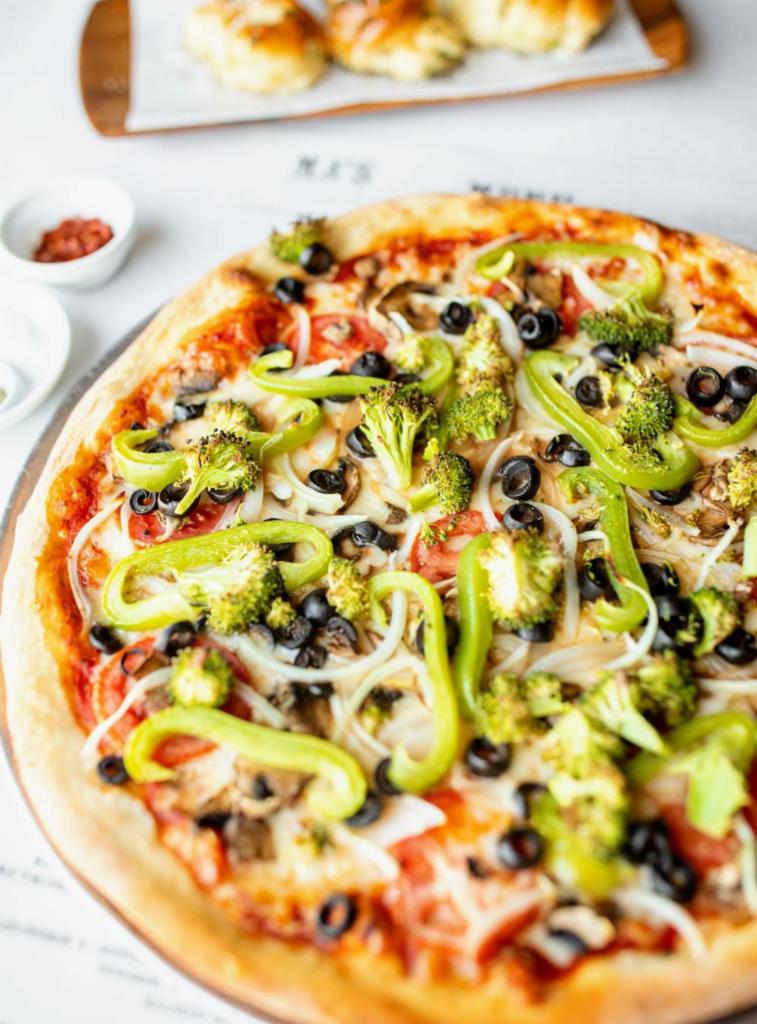 Veggie Pizza · Marinara, mozzarella, bell peppers, black olives, broccoli, mushrooms, onions and tomatoes.