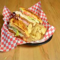 Club Sandwich · Roasted turkey breast, ham, lettuce and tomato on our signature bread.