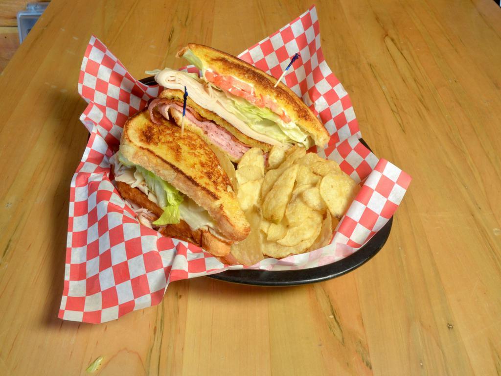 Club Sandwich · Roasted turkey breast, ham, lettuce and tomato on our signature bread.