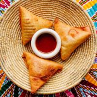 Lentil Sambussa (VG) · 3 pieces. Fried dumplings, served with a sweet and spicy honey awaze sauce. Contains gluten ...