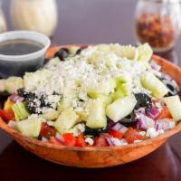 Greek Chopped Salad · Romaine and iceberg, black olives, tomatoes, red onions, cucumbers and feta cheese.