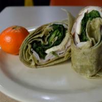 Turkey and Brie · Wheat wrap, Brie cheese, turkey and spinach with a side of cranberry sauce.