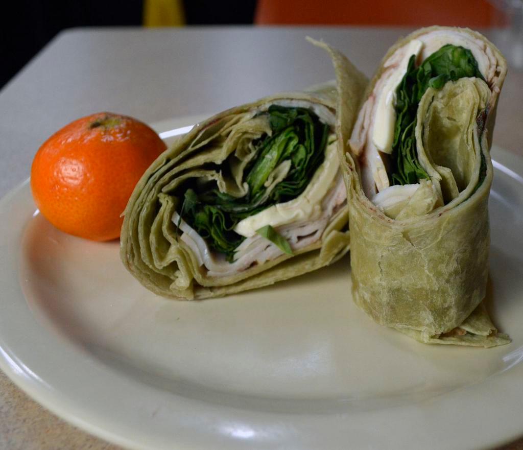Turkey and Brie · Wheat wrap, Brie cheese, turkey and spinach with a side of cranberry sauce.