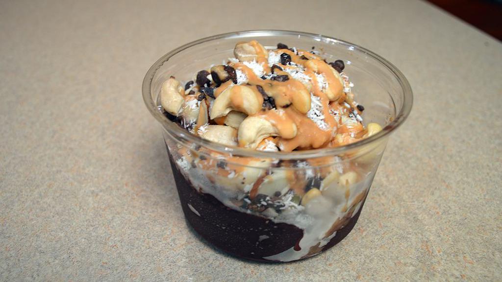 Açai Protein Bowl - 16 oz · 22g-28g protein. Açai & peanut butter topped with granola, almonds, cacao nibs, cashew, coconut & banana.