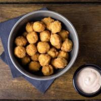 Popcorn Chicken · Breaded chicken bites served with a side of chili aioli.