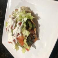 Tostadas · Topped with beans, lettuce, tomato, sour cream, and cheese