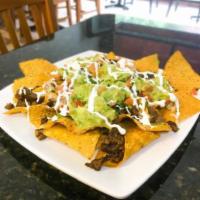Nachos · Nacho cheese, beans, sour cream, guacamole and jalapenos. Choice of meat: pork, chicken, or ...