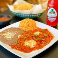 Huevos Rancheros · 2 eggs over a fried tortilla soaked in ranchero sauce. Served with rice and beans.