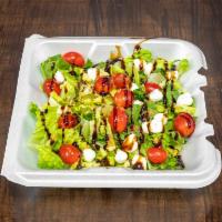 Regular Caprese Salad · Chopped romaine lettuce, roasted grape tomatoes, mozzarella, roasted garlic and oil, fresh b...