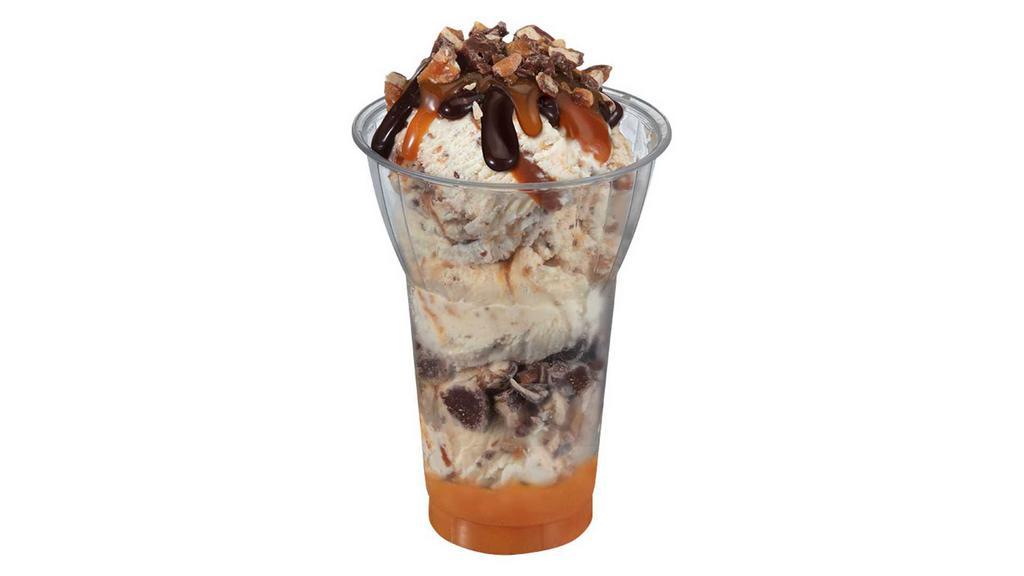 Made with Snickers Layered Sundae · 3 scoops of made with snickers ice cream, crushed snickers pieces and caramel layers, topped with caramel, hot fudge and snickers pieces. Delivered products will not include whipped cream.