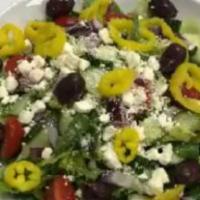 Greek Salad · Freshly cut romaine, vine-ripened tomatoes, red onions, feta, Kalamata olives, peppers, slic...