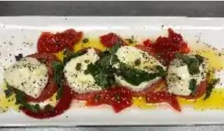 Caprese Salad · Fresh mozzarella, tomato slices, roasted red peppers, caper berries, and fresh basil. Drizzl...