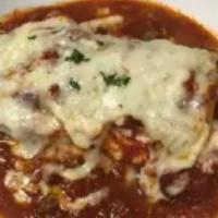 Meat Lasagna · Homemade pasta layered with ricotta, mozzarella, Romano, ground beef, and marinara sauce. Ba...