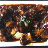 Ribs · Tender fall-off-the-bone pork ribs smothered in tangy BBQ sauce.