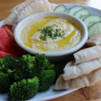 Hummus · Homemade hummus served with pita bread and veggies.