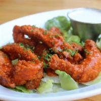 Buffalo Chicken Strips · Fried chicken strips tossed in Buffalo sauce and served with ranch or bleu cheese.