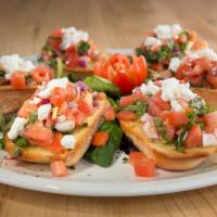 Bruschetta · Toasted garlic bread topped with tomato, extra virgin olive oil, red onion, basil and goat c...
